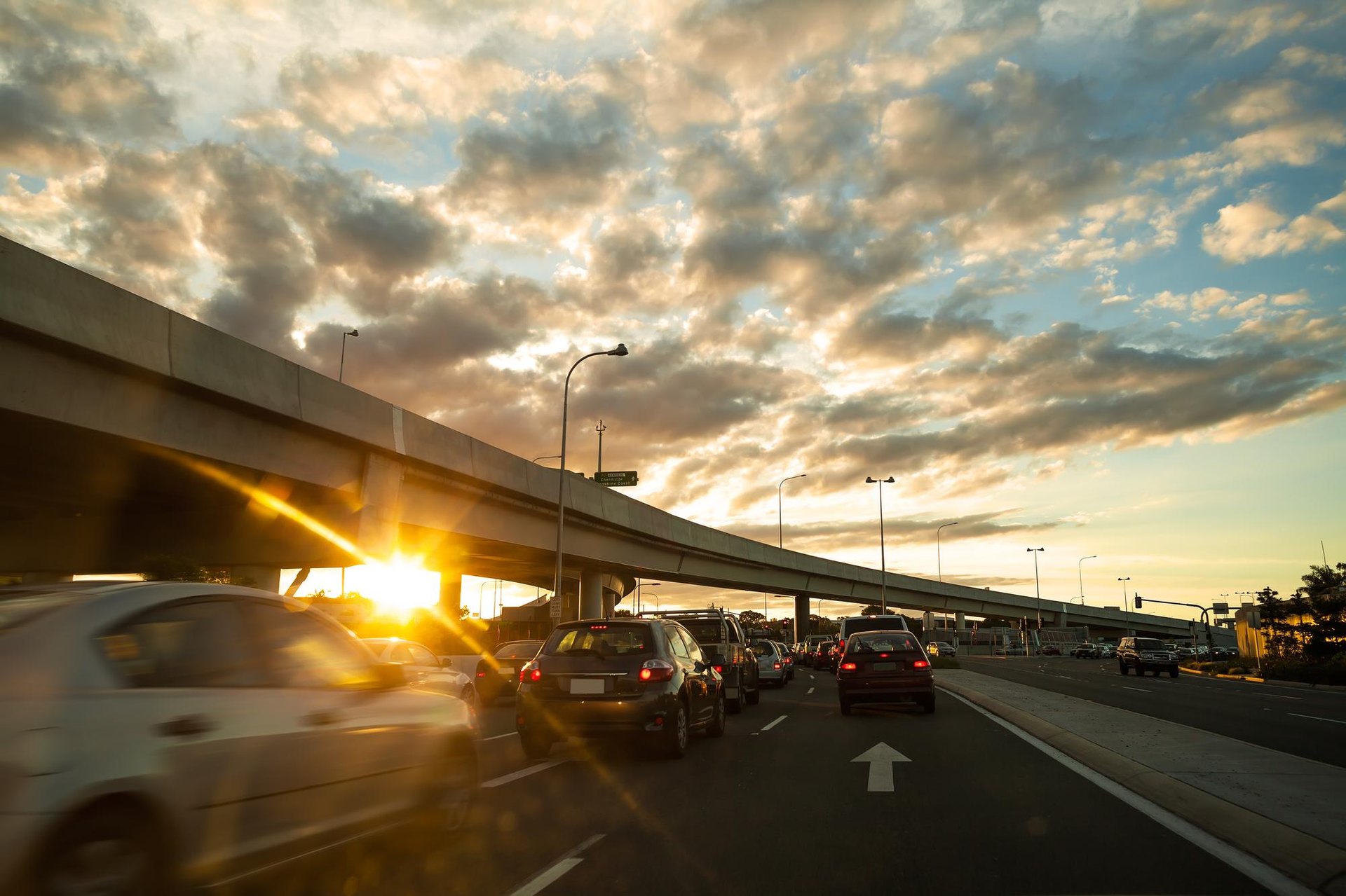 Early-morning commute traffic on a Roseville, California highway at sunrise.