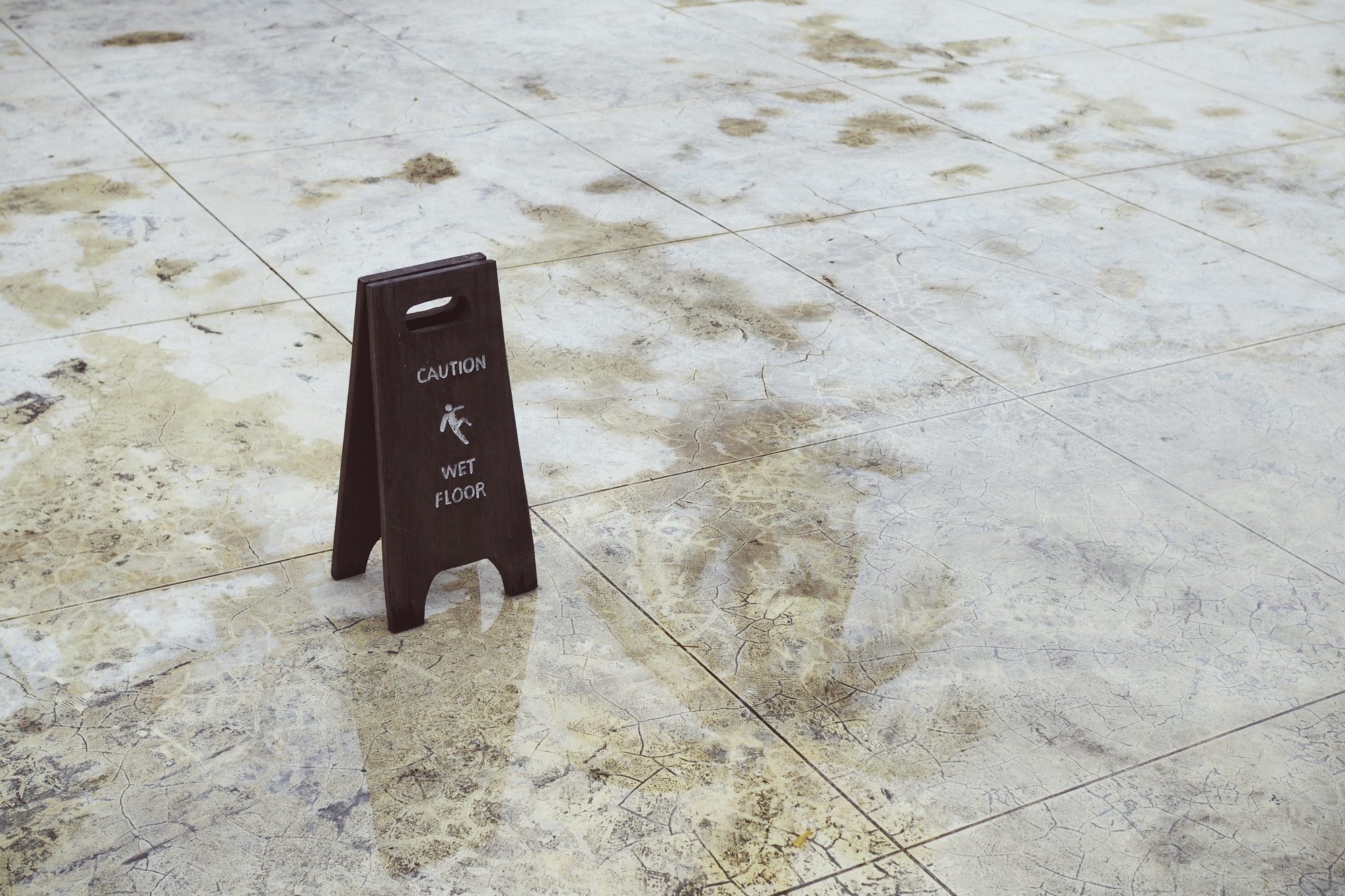 Wet floor caution sign on a tiled walkway in Sacramento, California