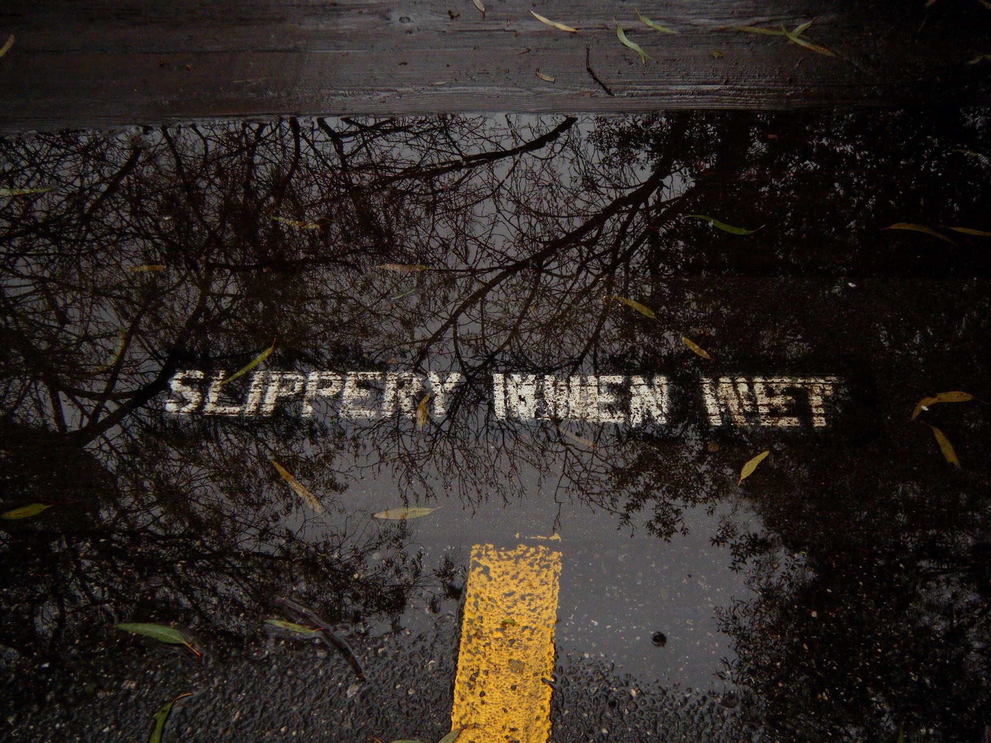 Slippery-when-wet hazard sign — Roseville premises liability lawyers
